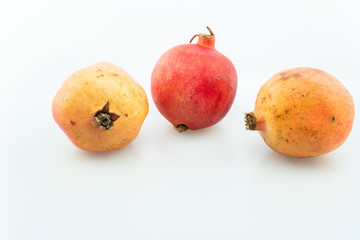 Ripe pomegranates fruit on white background.
pomegranates are used in baking, cooking, juice blends, meal garnishes, smoothies, and alcoholic beverages, such as cocktails and wine.