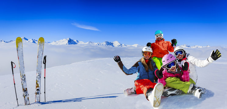 Ski in winter season, mountains and ski touring equipments on the top in sunny day in France, Alps above the clouds.