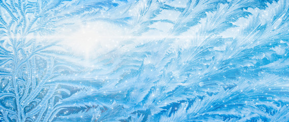 Wide blue winter background, frozen icy window, weather forecast concept