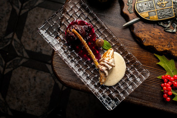 Deer steak on a black background. A Halloween Meal.