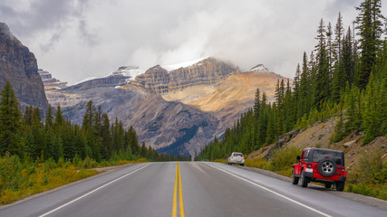 Cars pulled over along side the road with the mountain view