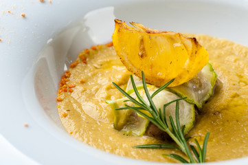 Pumpkin cream soup with fish som. A Halloween Meal.