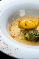 Pumpkin cream soup with fish som. A Halloween Meal.