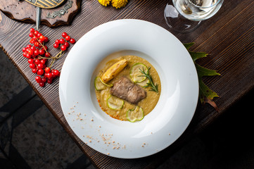 Pumpkin cream soup with fish som. A Halloween Meal.