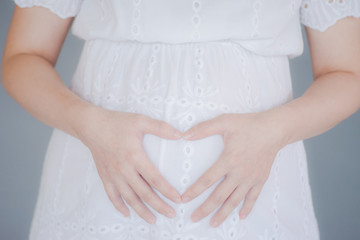 Obraz na płótnie Canvas Close up of a cute pregnant belly