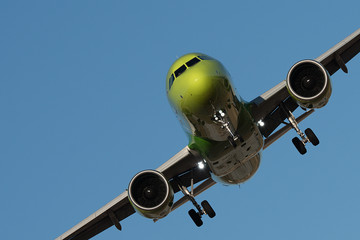 Large passenger plane flying in the blue sky