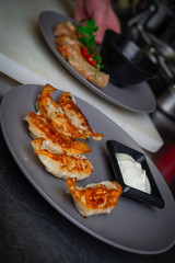A dish of Asian cuisine in the kitchen in the restaurant. Gedza dumplings fried with sauce.
