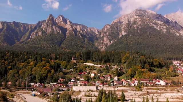 Aerial view of Busteni ski resort in Prahova valley and Bucegi mountain part of Carpathian mountains. Brasov region in Transilvania, Romania. Sunny autumn landscape