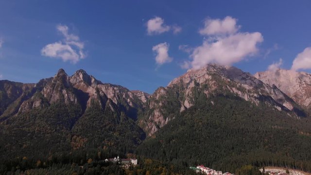 Aerial view of Busteni ski resort in Prahova valley and Bucegi mountain part of Carpathian mountains. Brasov region in Transilvania, Romania. Sunny autumn landscape