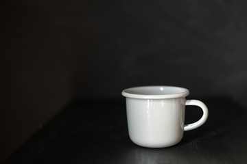 A large gray mug for drinks on a dark background. Template with empty space.