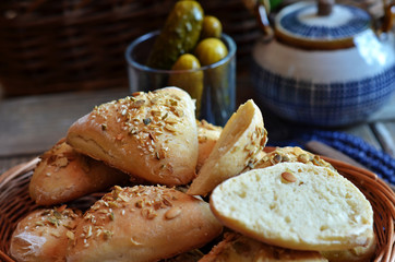 Triangular buns with seeds in a small basket