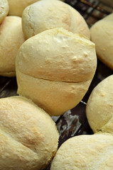 Freshly baked dinner rolls on wooden background