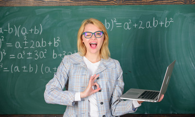 Woman wear eyeglasses holds laptop surfing internet. Educational site for teachers. Educator smart...