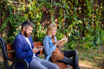 Man with beard and woman read alternative information storage. Read book in park pleasant leisure....