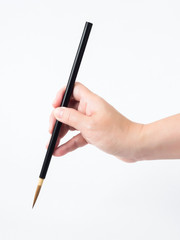 Woman hand and black brush