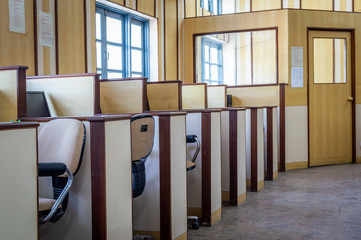Small individual cabins with computers and chairs in an office