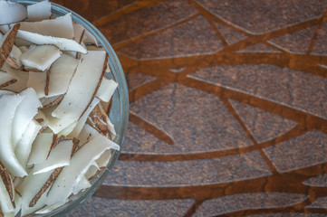 Chopped coconut in a bowl on a wooden table