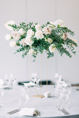 Stylish wedding decor and decoration of the hall. The bride's bouquet and dress, European part. the minimalism and simplicity of the decor