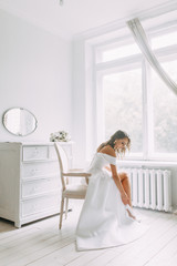 A concept wedding, contemporary European bride. Bouquet of flowers, fees in the interior Studio. Ideas for a minimalist wedding, white color