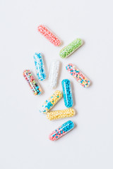 top view of different colorful medical capsules on white
