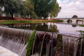 Fototapeta premium Landscape Of a Bridge Over a River Under a Beautiful Sky