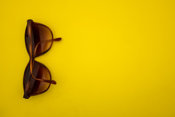 Sunglasses on a yellow background.