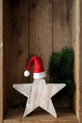 Christmas decoration Santa Clause hat on a star in a wooden box background