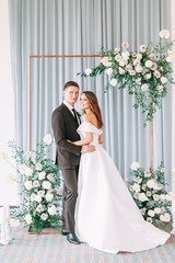 Stylish European wedding ceremony. The bride and groom are surrounded by guests. Arch and decor of fresh flowers. .Wedding ideas