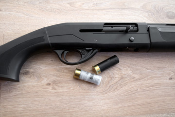 semi-automatic black hunting shotgun and cartridges 12 gauge, close-up view