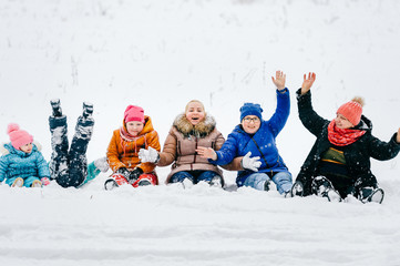 Generation Female - Grandmother, Mothers, Daughters, Granddaughters. Relatives all together sitting happy in snow at field. Big loving funny family at winter picnic have fun. Adults and children joy.