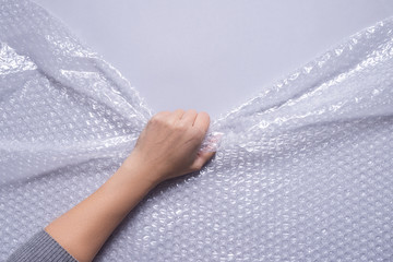 The hand pulls the bubble film