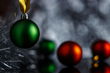 Christmas or New Year concept. Colored balls, silver tinsel and bokeh decorate the Christmas composition. Cold northern light (moonlight) illuminates the New Year scene. There is room for copy space.