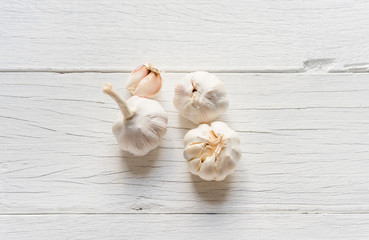Organic garlic whole and cloves on wooden background.