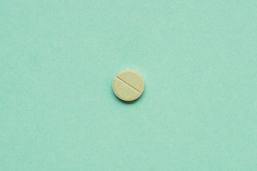 top view of round tablet on green background