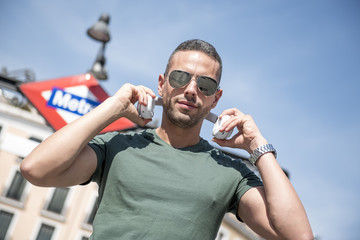 Handsome man posing in the center of the city