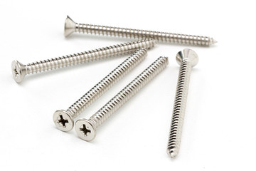 Close-up on screws, metal screws, iron screws, wood screws isolated on white background