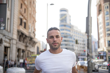 Handsome man posing in the center of the city