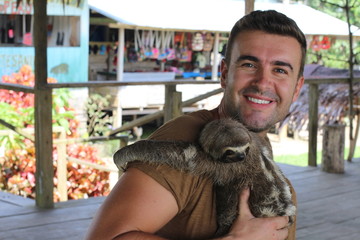 Lovely sloth hugging a man  © ajr_images