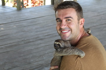 Tender man taking care of a sloth © ajr_images