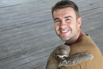 Sloth hugging a handsome man  © ajr_images