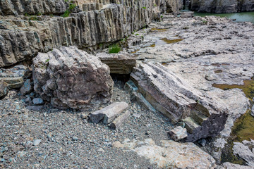 Daytime spring view taken at the amazing Devil's Canyon natural phenomenon in Bulgaria, also known as Sheytan Dere near Studen Kladenetz reservoir in Rhodope Mountain. Wonderful green waters