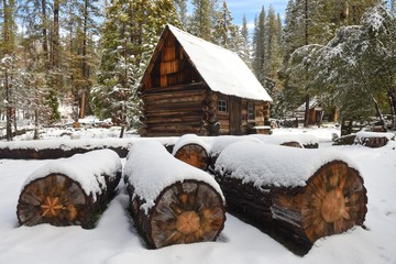 Rustic old cabin surrounded by snow in the forest near Yosemite