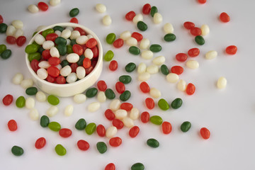 Christmas colors white, greed, red candies jelly beans on white background.