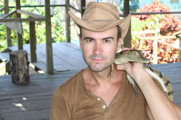 Naklejka premium Man holding baby reptile with copy space