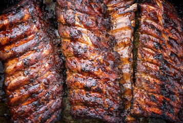 Barbecue spare ribs St Louis cut with hot honey chili marinade as top view copy space and food texture