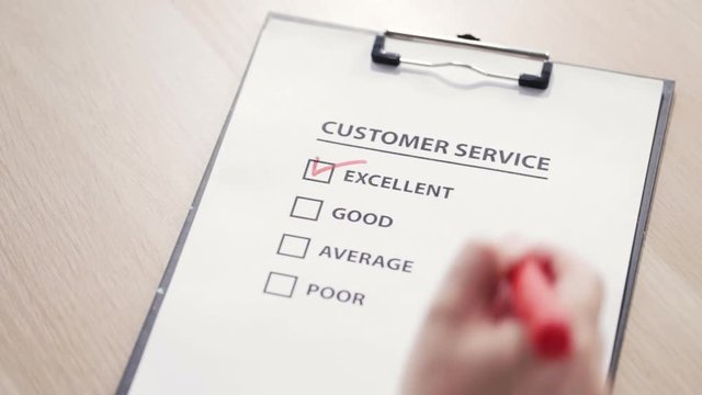 Man putting a check sign at "excellent" square at a customer satisfaction survey