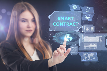 The concept of business, technology, the Internet and the network. A young entrepreneur working on a virtual screen of the future and sees the inscription: smart contract