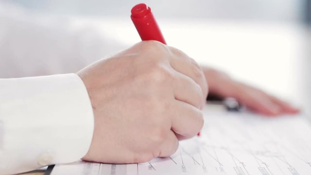 Man checking some reports or graphs, doing paperwork