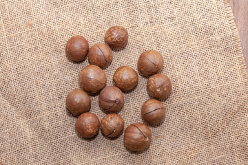 close up of organic macadamia nut on sack