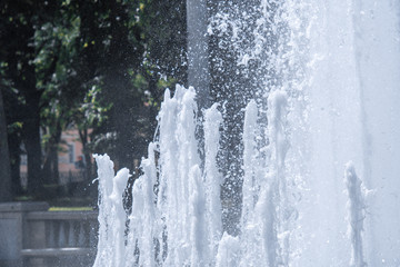 Fototapeta na wymiar Fountain water in park close up